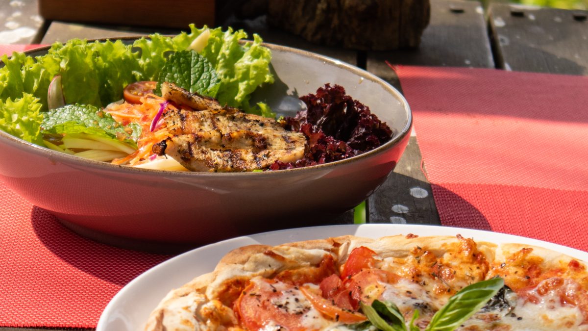 Hillside dining table overlooking lush jungle scenery.