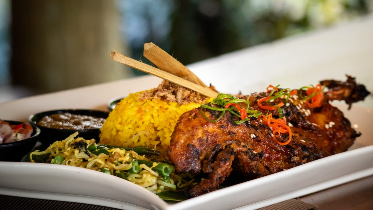 Outdoor table setting with lush green forest scenery, representing a peaceful forest view dining experience.