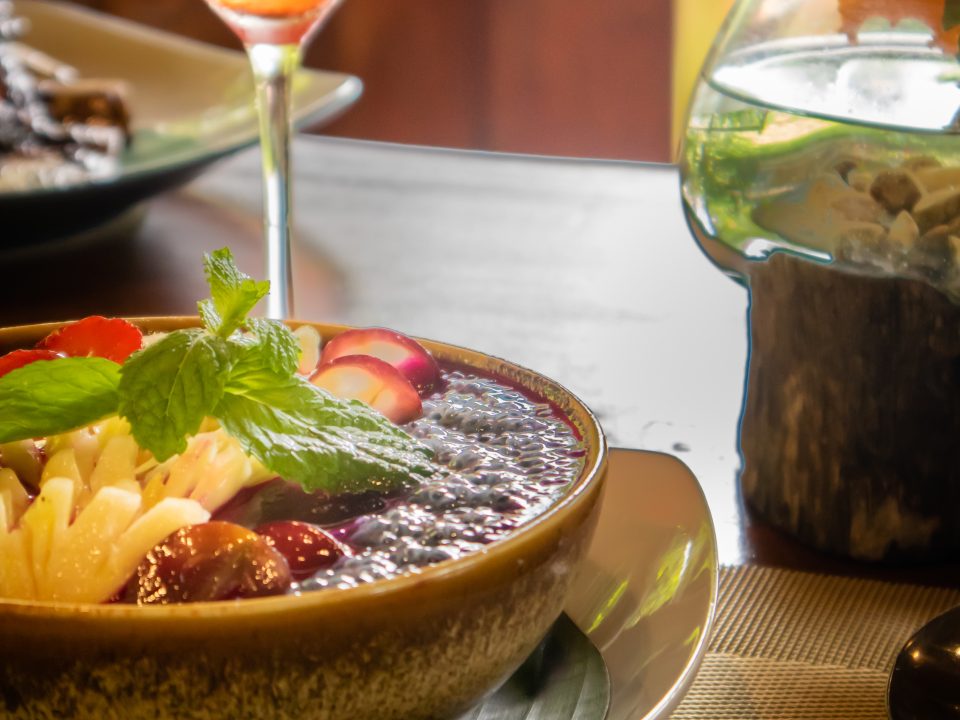 Open-air wooden dining deck showcasing a nature dining experience in Bali