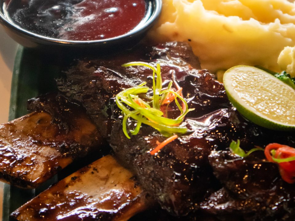 Open-air wooden table set for a forest dining experience in Bali
